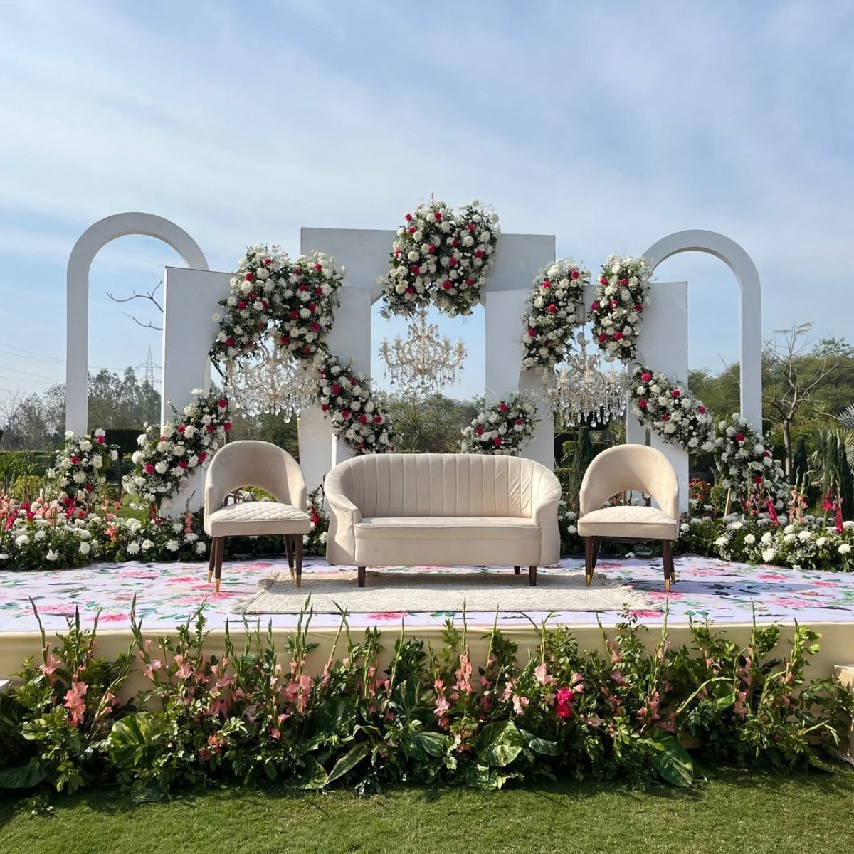 Bespoke floral mandap installation with ivory and blush roses and architectural lighting